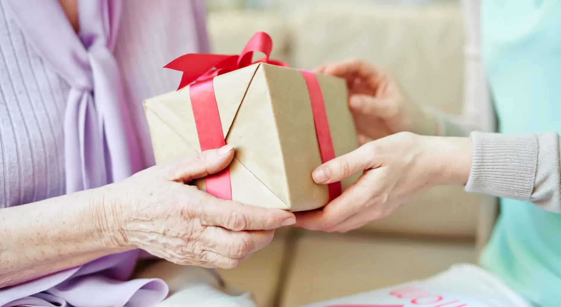 Hands passing gift to another 